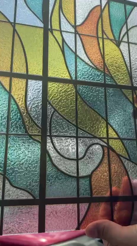 Close-up of hand-set stained glass panel during fabrication
